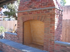Rumford style fireplace was built out of Robinson Cambridge brick and roofing tiles with Eldorado capping stones. 