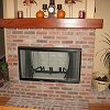 Brick Fireplace and raised hearth - custom wood mantel
