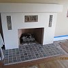 Custom Plaster Fireplace with mosaic tile hearth and inlaid Batchelder tiles