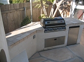 Custom masonry outdoor bbq island and fireplace