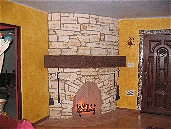 Rumford style fireplace with Eldorado stone veneer, spanish tile hearth, and custom wood mantle