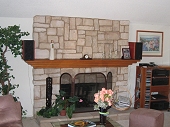 Eldorado Stone veneer fireplace and hearth, brick firebox, and custom wood mantle