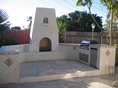 Outdoor stucco fireplace and barbecue island