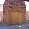 Custom masonry outdoor rumford style brick fireplace