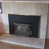Travertine and Black Marble Tiled Fireplace - decorative gas log set