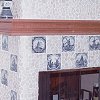Custom Masonry Stone Tile Fireplace and raised hearth - inlaid Dutch theme decorative tiles - custom wood mantel and high shelf