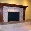 Mosaic Tile Face Fireplace with travertine tiled raised hearth - custom wood mantel and surround