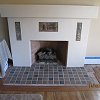 Plaster Fireplace with decorative tile inlays and tiled hearth