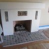 Plaster Fireplace with decorative tile inlays and tiled hearth